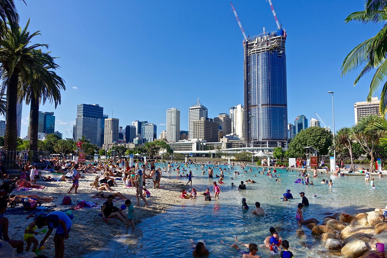 Beach and city skyline in Brisbane, showcasing a lively day at the city beach. House sitting on the Gold Coast offers a great way to explore local beaches while ensuring your pets are cared for