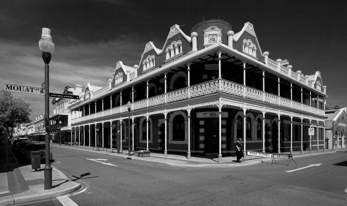 Black and white image of a historic corner building with intricate Victorian-style architecture in Fremantle, Australia.
