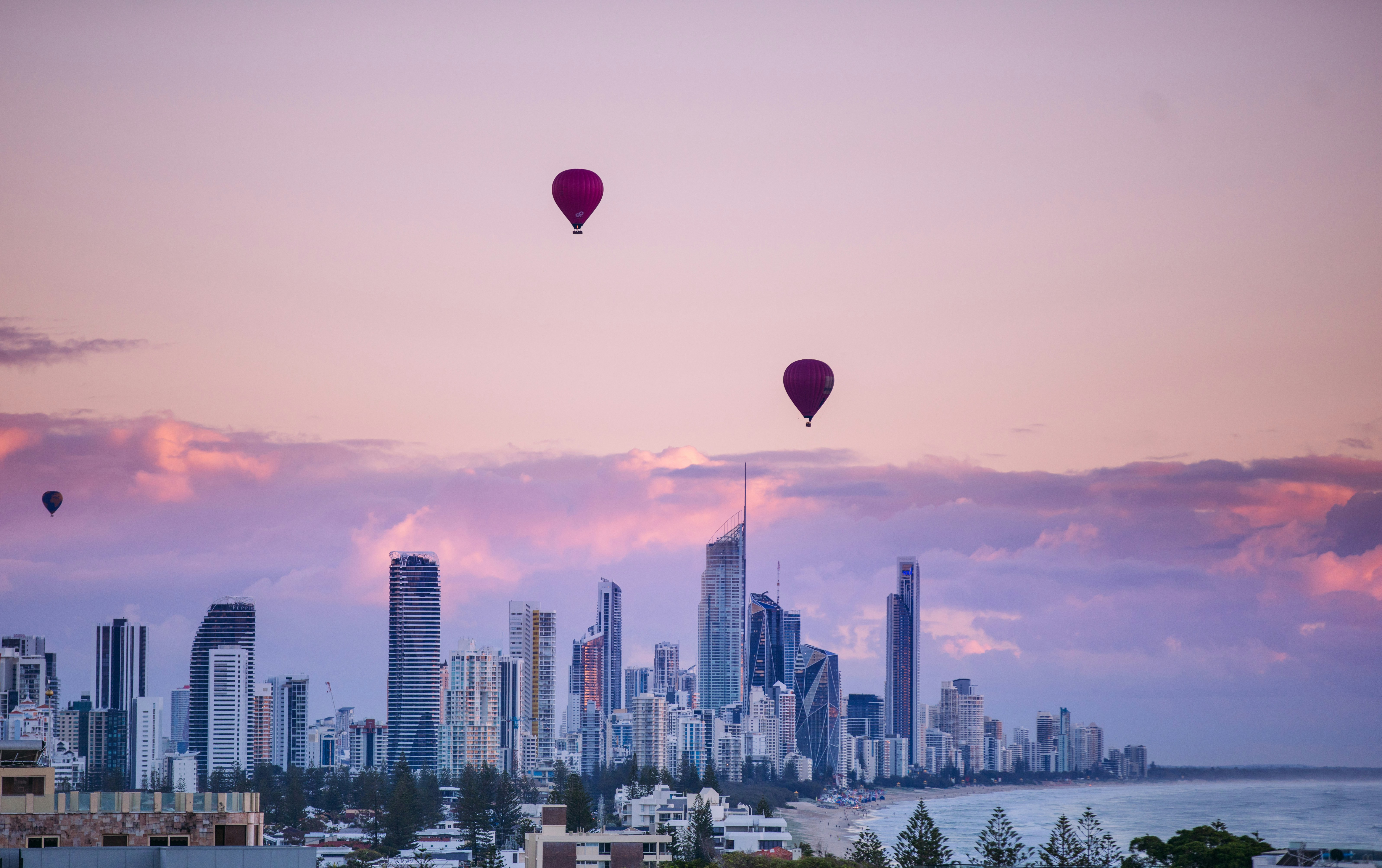 Beach and city skyline in Brisbane, showcasing a lively day at the city beach. House sitting on the Gold Coast offers a great way to explore local beaches while ensuring your pets are cared for